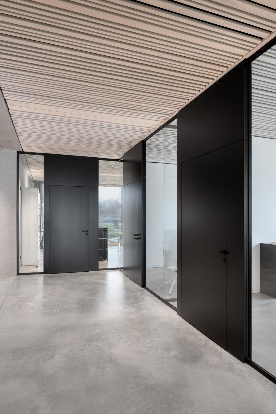 Nething Architects | hallway with black doors and glass wall