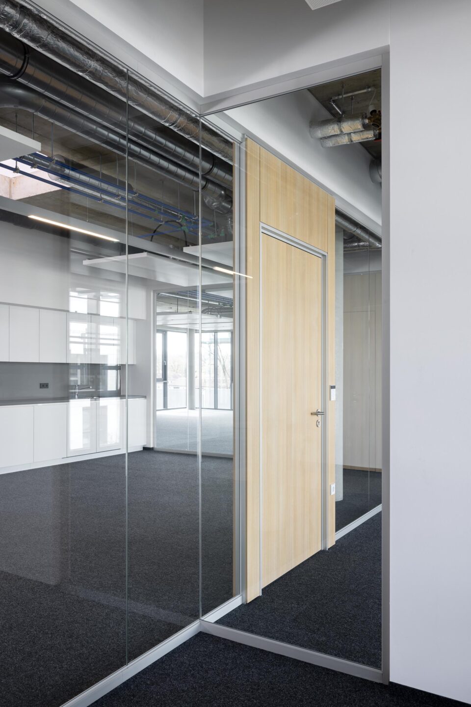 Erhardt + Leimer electrical installations | combination of wooden door and glass walls